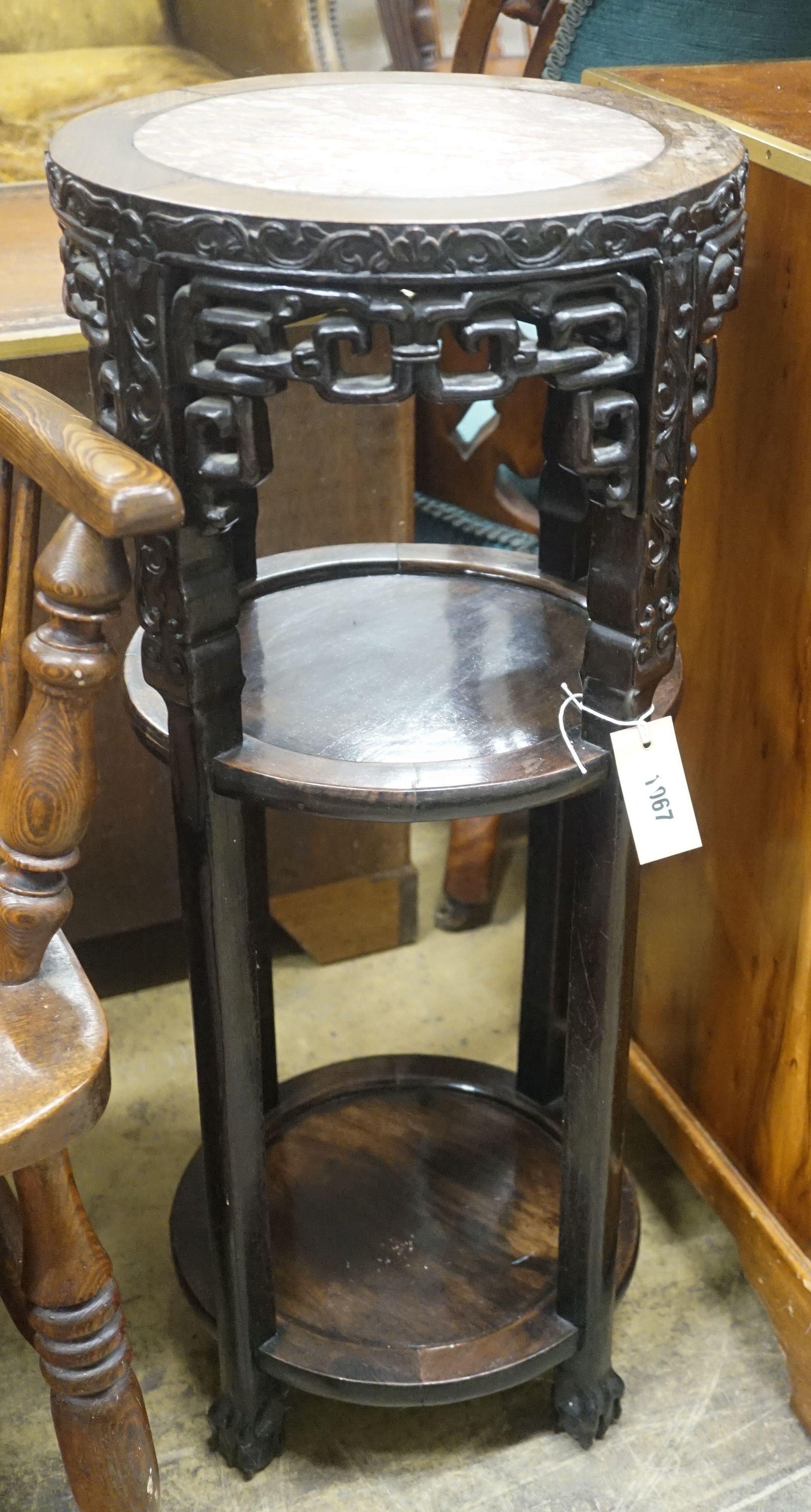 A Chinese circular marble topped padouk three tier vase stand, diameter 34cm, height 80cm